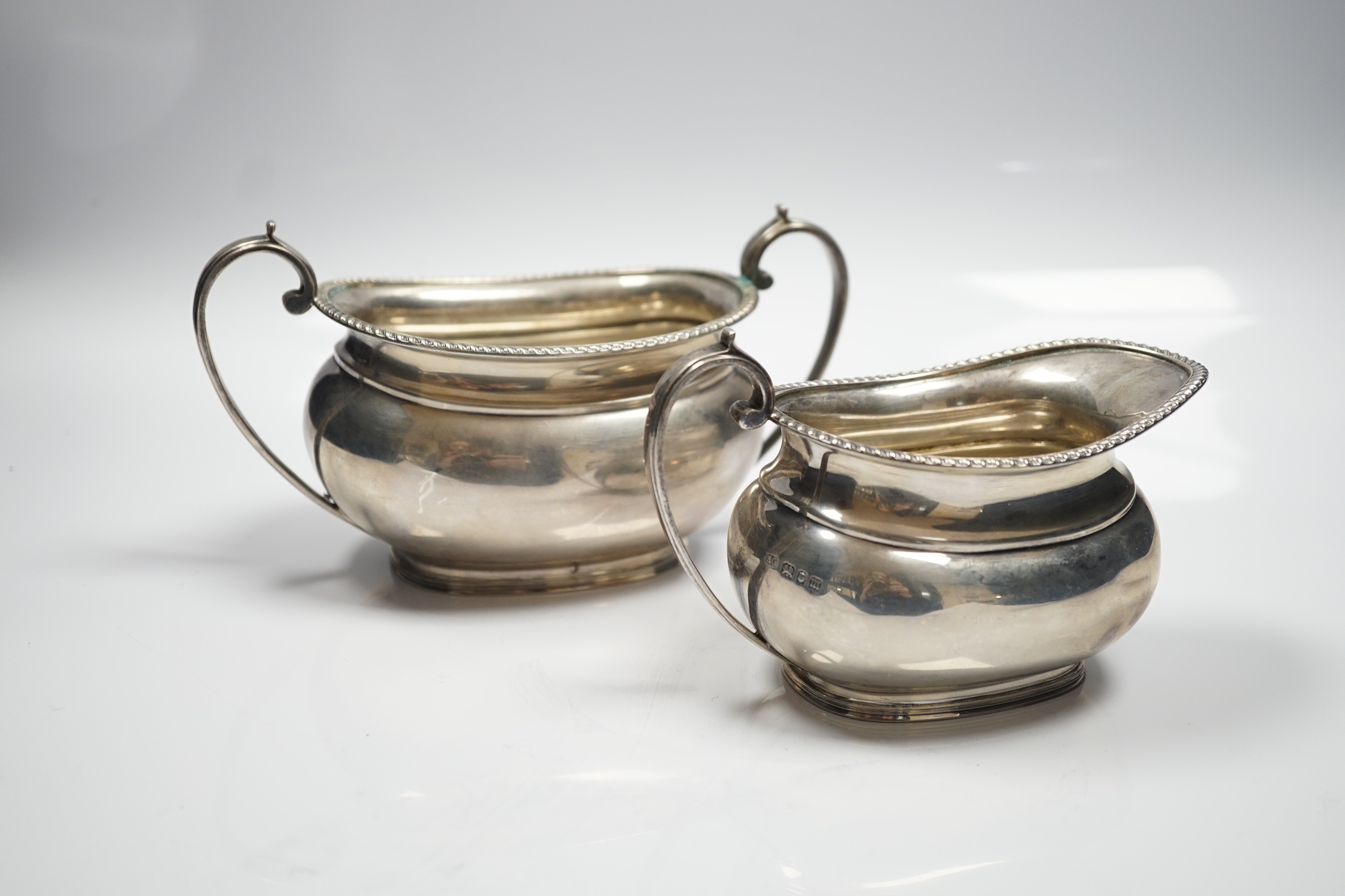 A George V silver oval cream jug and sugar bowl, Sebastian Garrard, London, 1927, 14.8oz.